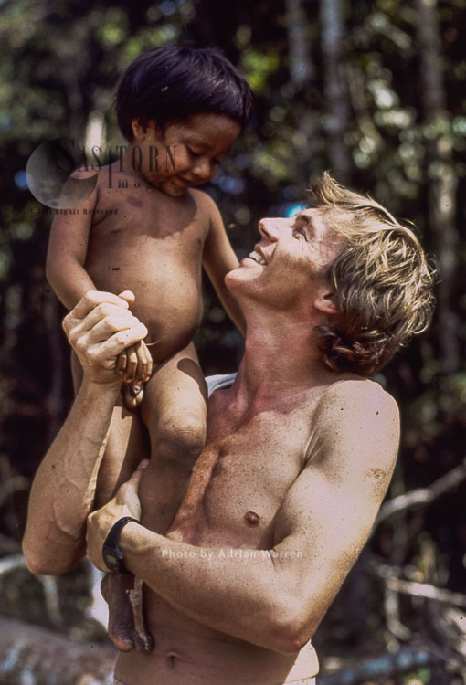 Waorani Indians, a child with Adrian Warren, Rio Cononaco, Ecuador, 1983