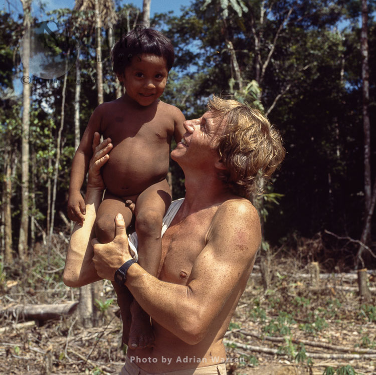 Waorani Indians, a child with Adrian Warren, Rio Cononaco, Ecuador, 1983