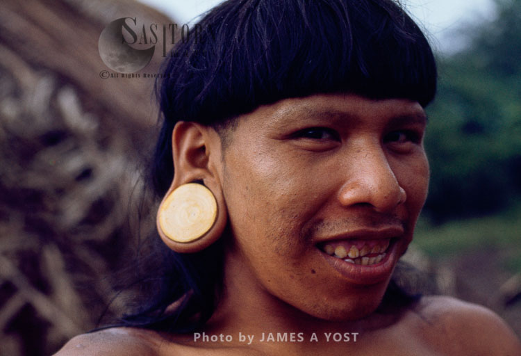 Waorani Indians, Stretching earlobes to their size in a month often causes infection and tears in the lobe, Gabado, near Rio Cononaco, Ecuador, 1973
