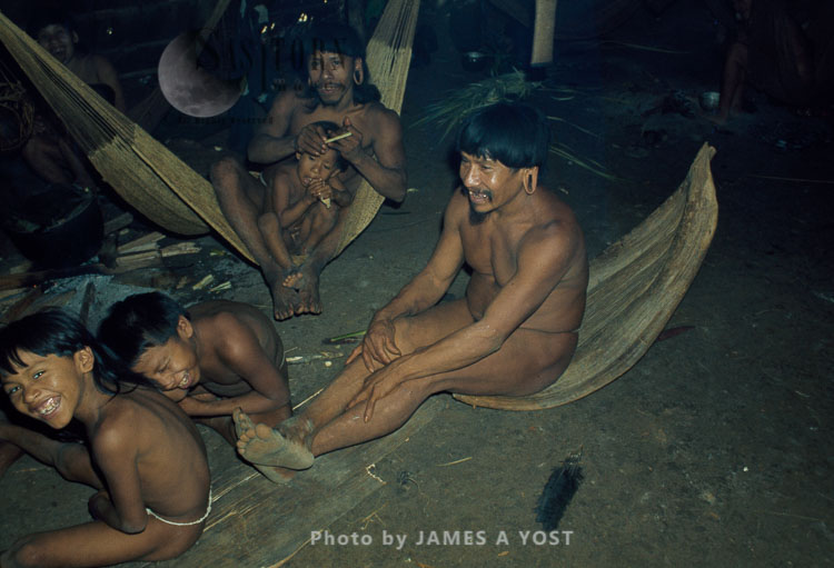 Waorani Indians: Visitors drag in a palm leaf-sheath to sit on and sleep in, Gabado, 1973, Ecuador
