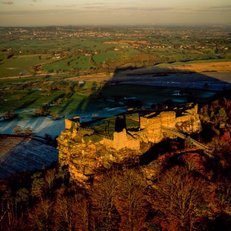 Beeston Castle, a former Royal castle in Beeston, Cheshire, England, perched on a rocky sandstone crag 350 feet above Cheshire Plain